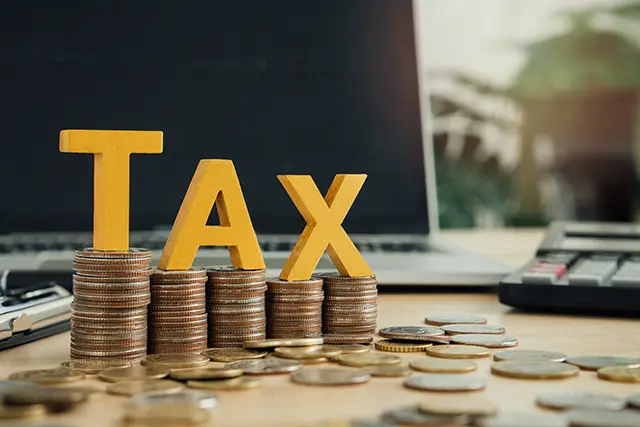 A collage of money and tax equipment.